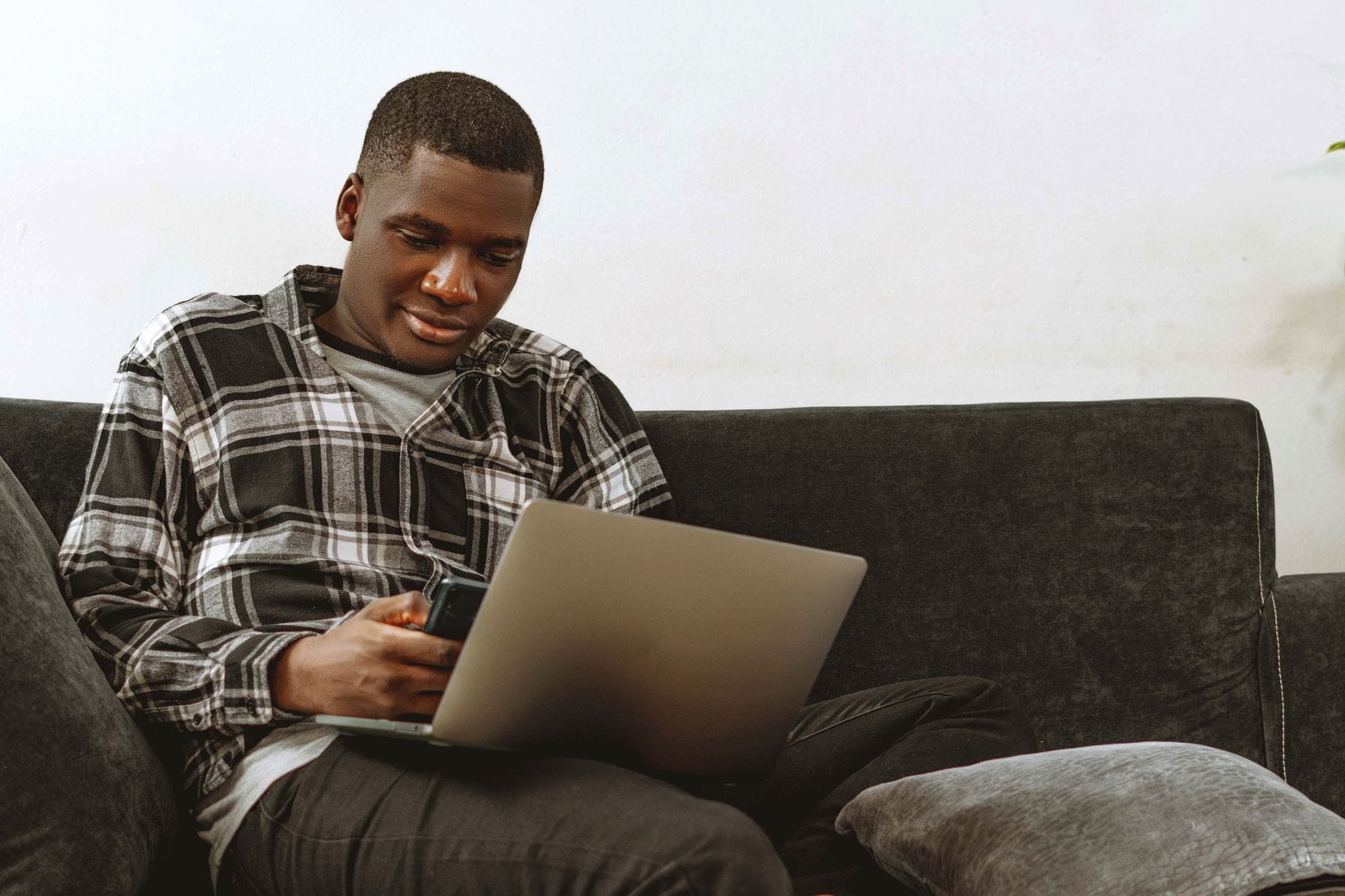 Starting a personal loan application online with a laptop and phone in Canada