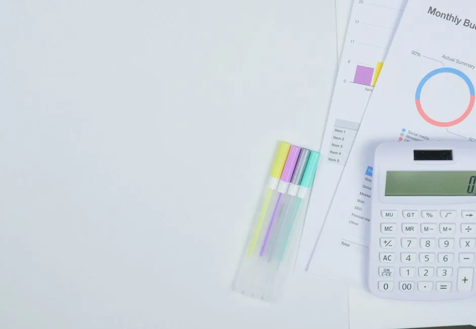 Calculator and monthly budget sheet estimating a fair credit loan payment