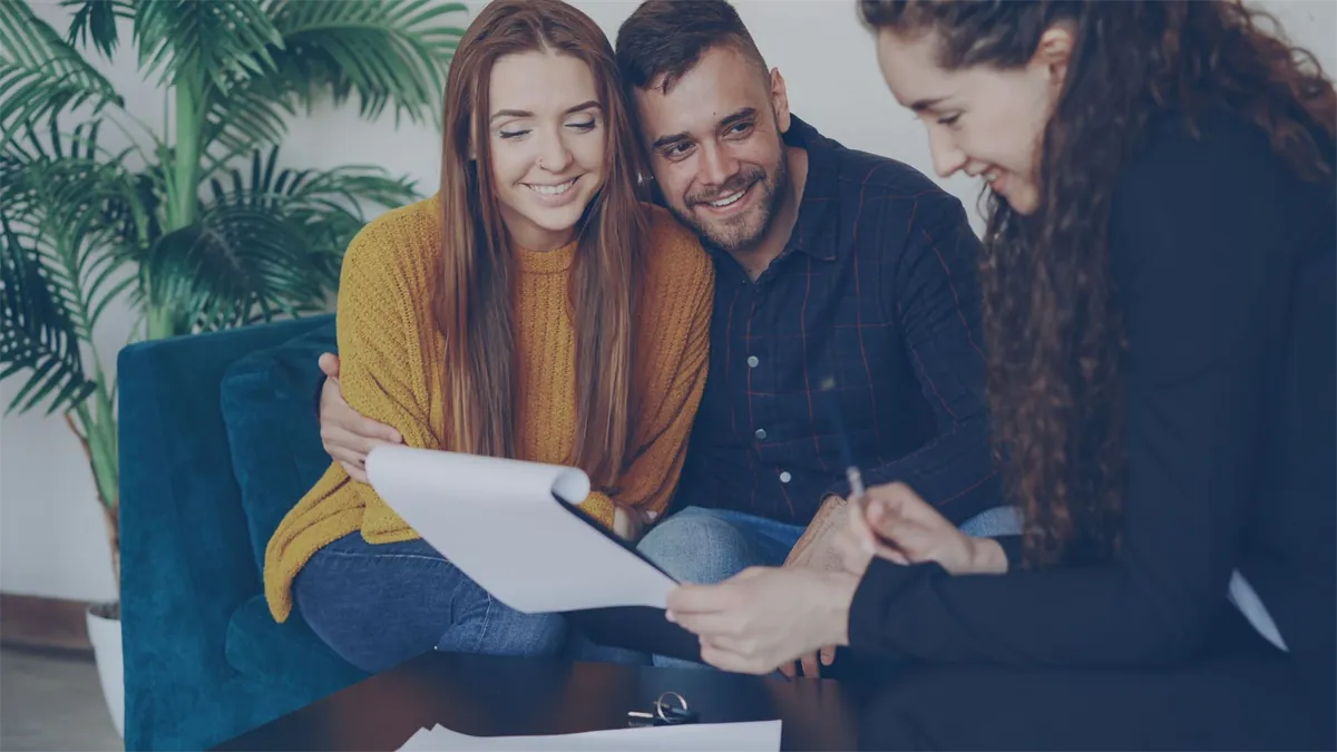 Couple approved for a low-interest personal loan reviewing offers with an advisor