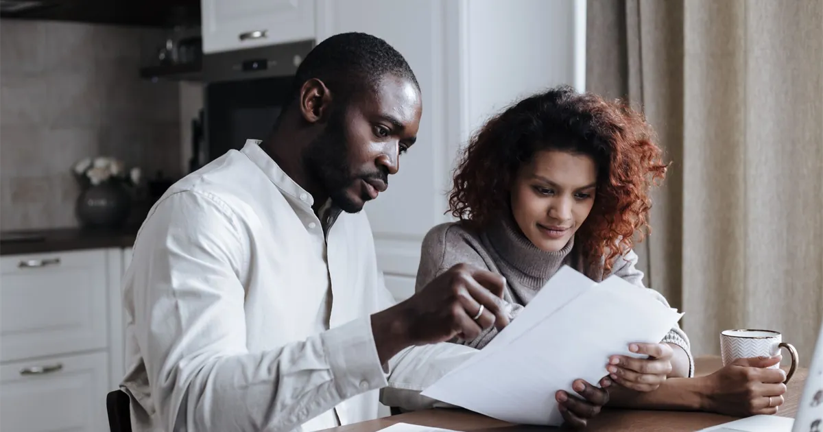 Couple comparing low-interest personal loans in Canada on a laptop at home
