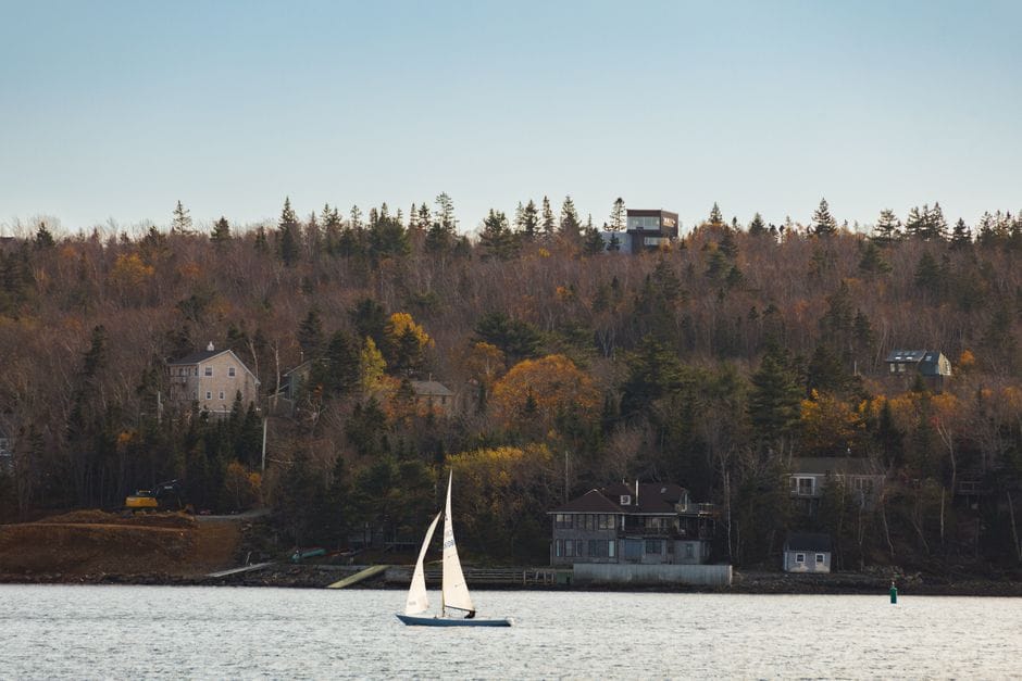 Nova Scotia coastal homes and a sailboat in autumn - personal loans Nova Scotia
