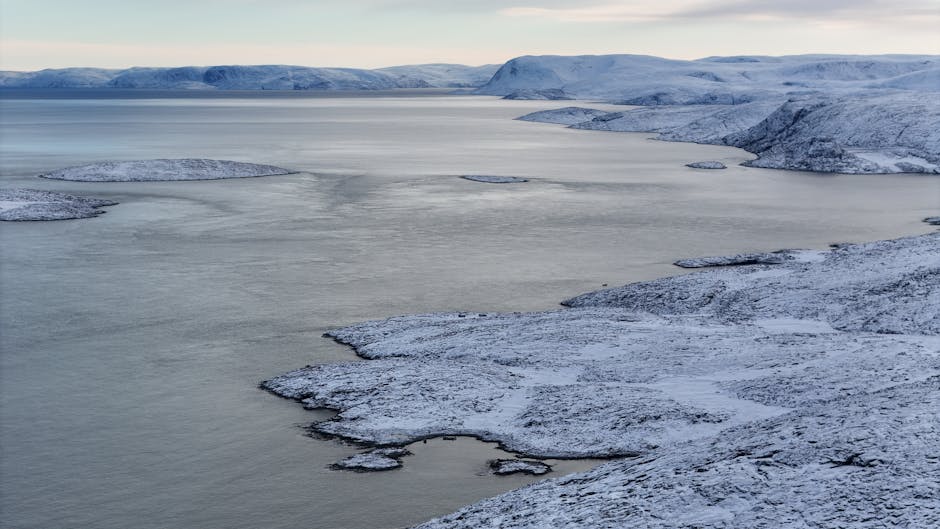 Snowy coastal landscape with calm Arctic waters in Nunavut, Canada - online personal loans Nunavut Territory