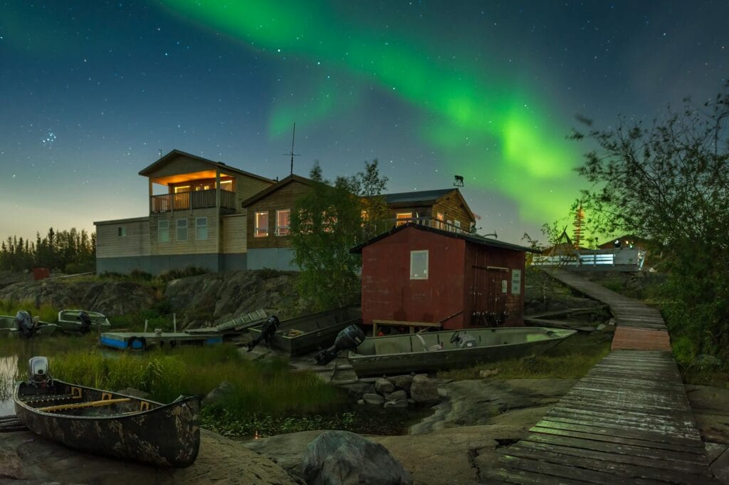 Aurora borealis over lakeside cabins in Yellowknife, Northwest Territories - online personal loans NWT