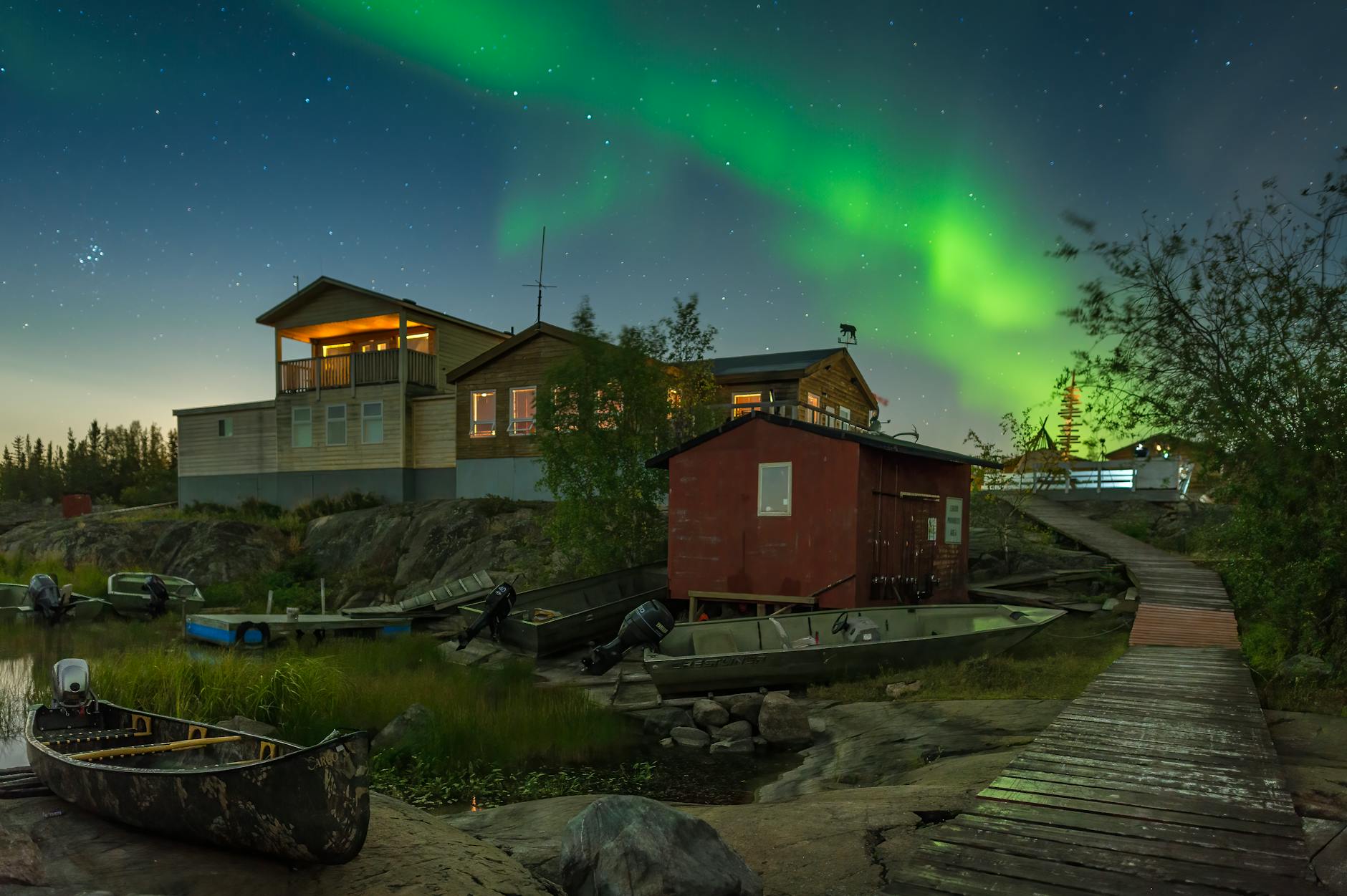 Aurora borealis over lakeside cabins in Yellowknife, Northwest Territories - online personal loans NWT