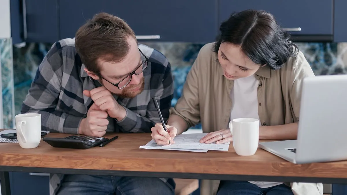 Couple reviewing the cost of a personal loan in Canada at home