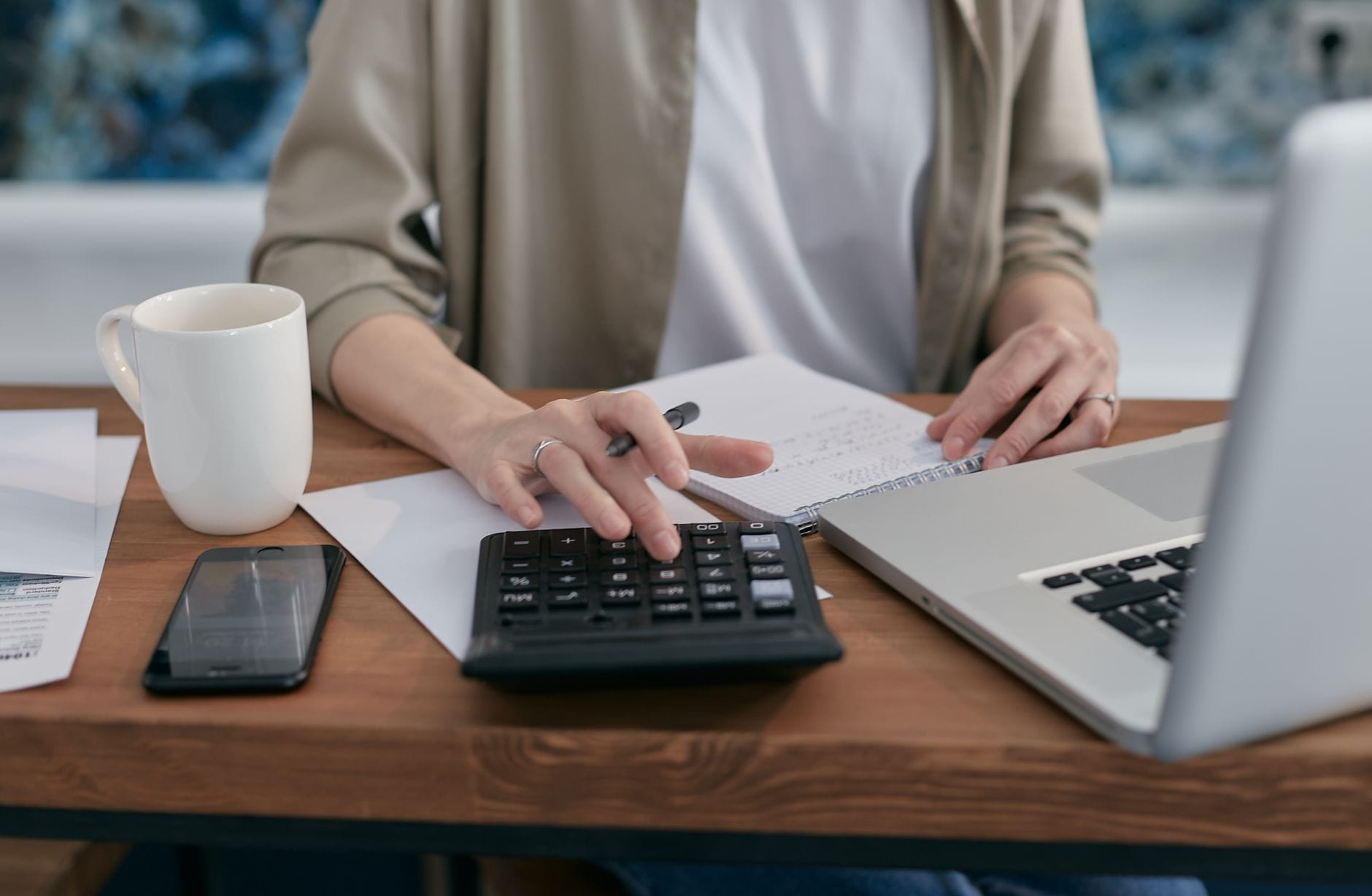 Organizing finances with a calculator and laptop - second chance loans in Canada