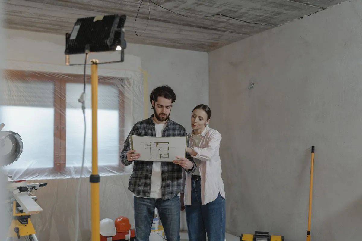 Couple reviewing home renovation blueprints funded by a 10000 dollar installment loan