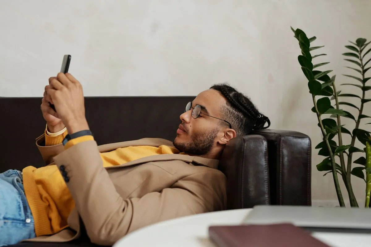 Borrower checking his $1500 loan approval on his phone at home