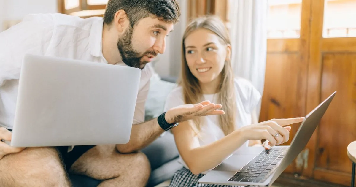 Couple comparing 1500 loan Canada offers on their laptops at home