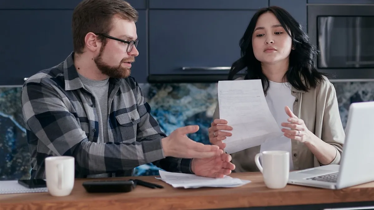 Couple reviewing 2500 loan eligibility documents at home