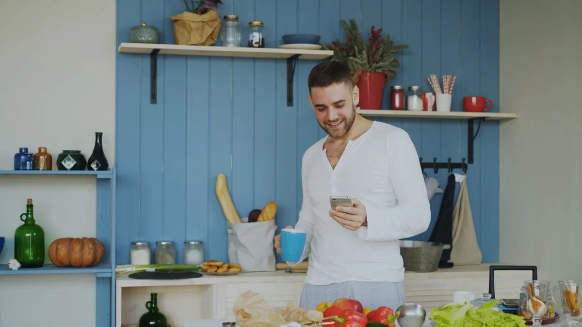 Man checking his 750 loan application on his phone at home