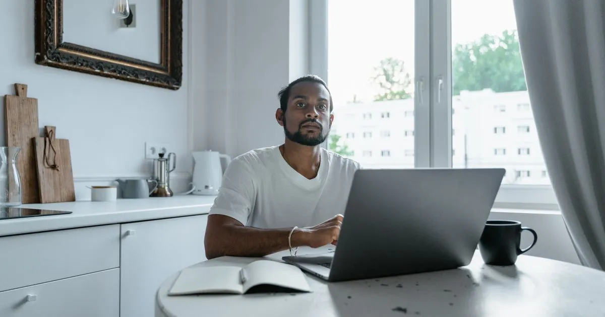 BC borrower applying online for an installment loan from his kitchen table