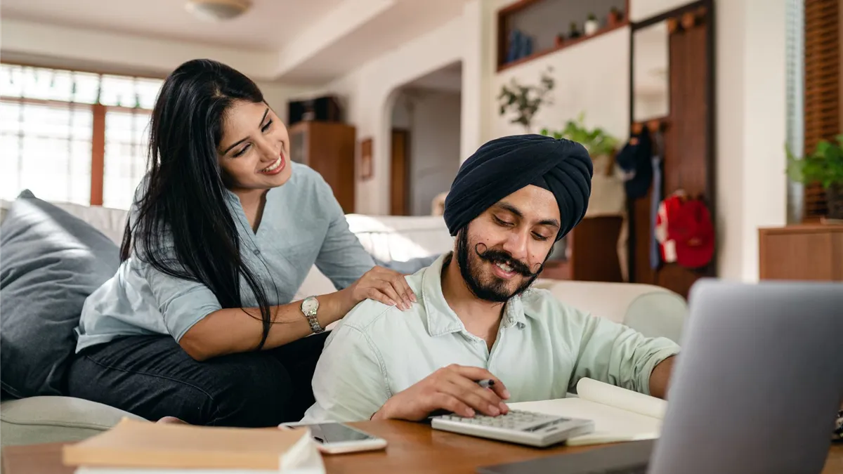Ontario couple comparing installment loan offers at home with a calculator and laptop