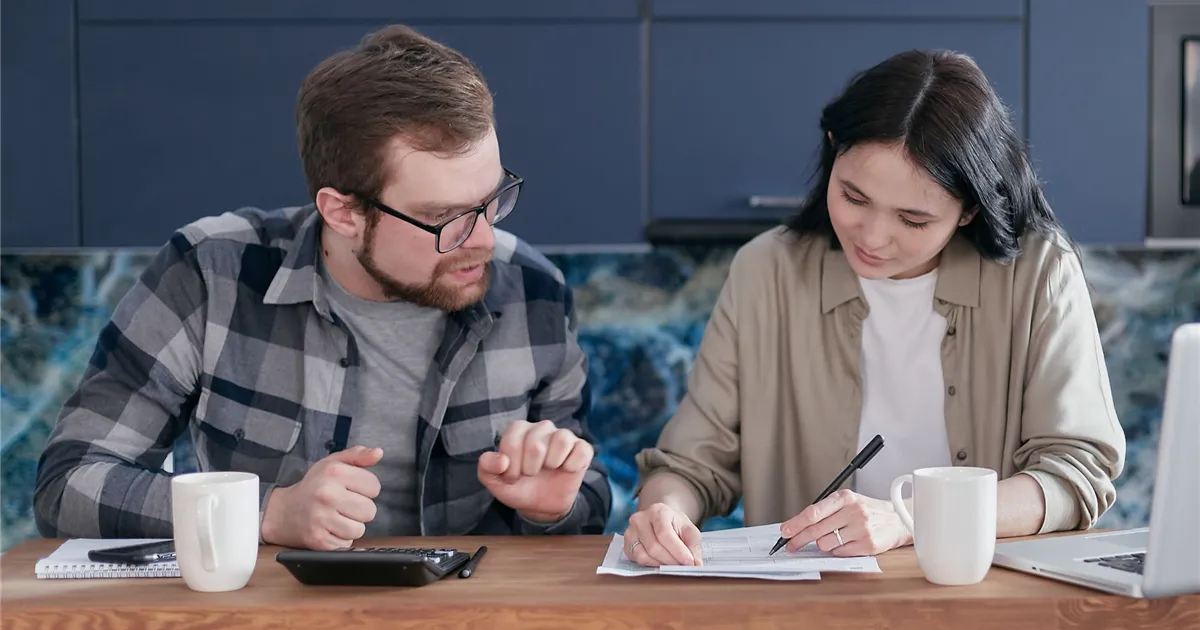 Nova Scotia couple comparing installment loan offers at their kitchen table