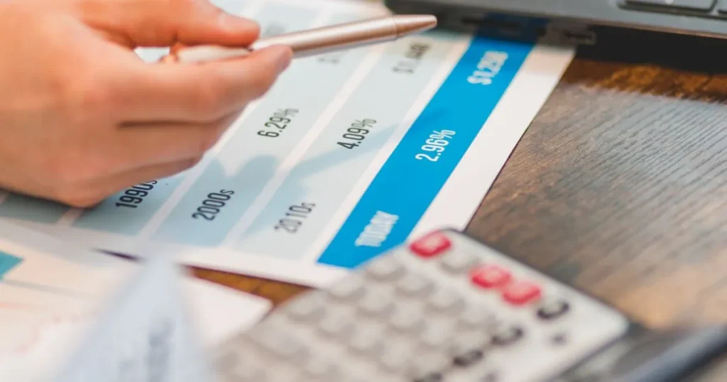 Reviewing personal loan rates in Canada on a printed interest rate chart with a calculator