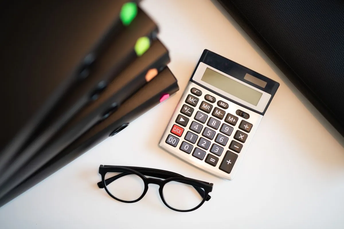Calculator and folders for working out monthly payments on a 1000 loan
