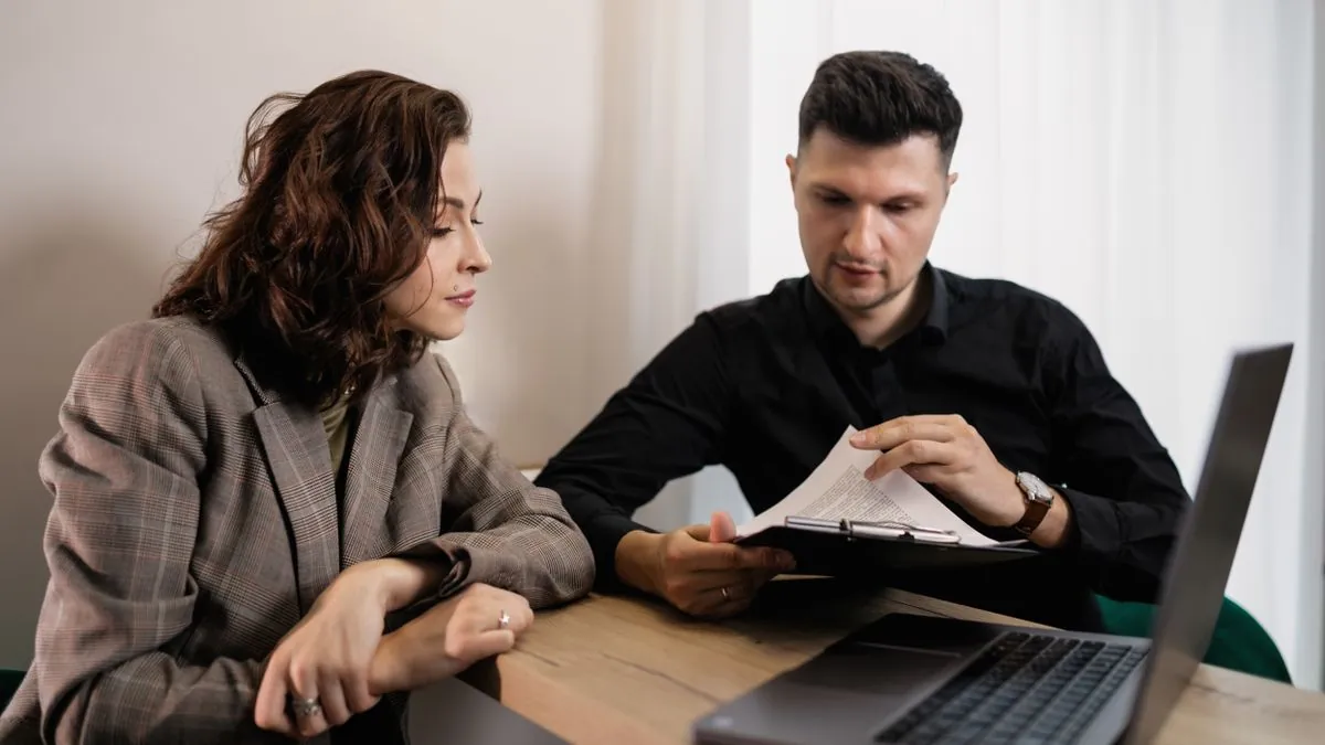 Reading the cost-of-borrowing disclosure on a low-interest personal loan agreement at home