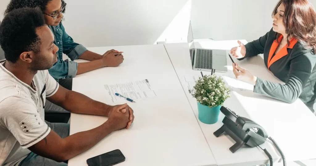 Couple meeting a loan advisor to compare secured vs unsecured loans in Canada