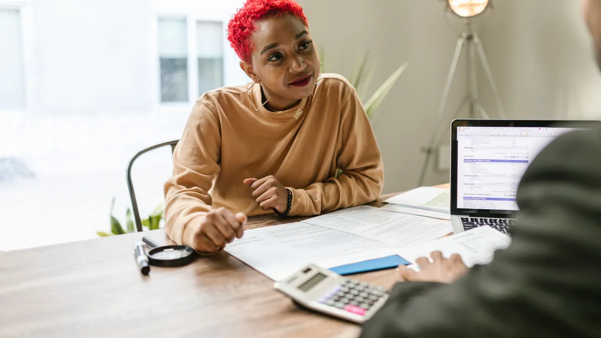 Woman talking through bad credit personal loans and her options with an advisor at a desk