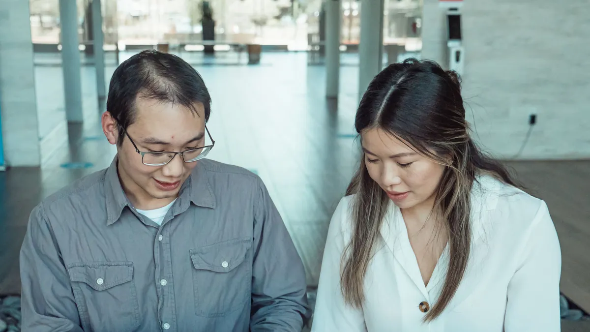 Borrower and cosigner reading a loan offer together before signing