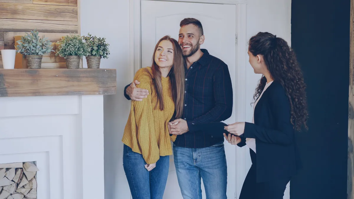 Couple going over personal loan terms with an advisor before signing